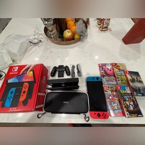Nintendo Switch OLED with Red and Blue Joy-Con Controllers and 5x Games